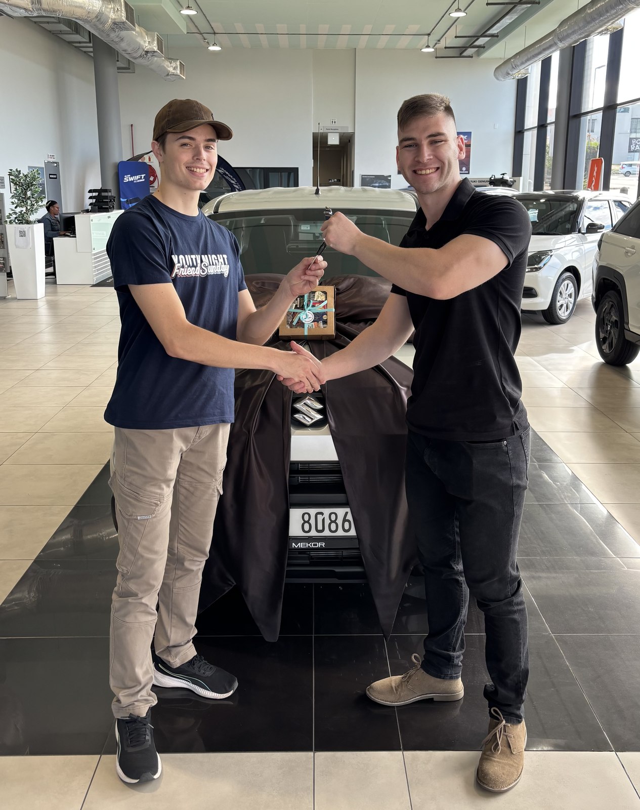 Client receiving keys to a new Suzuki from Jean Joubert