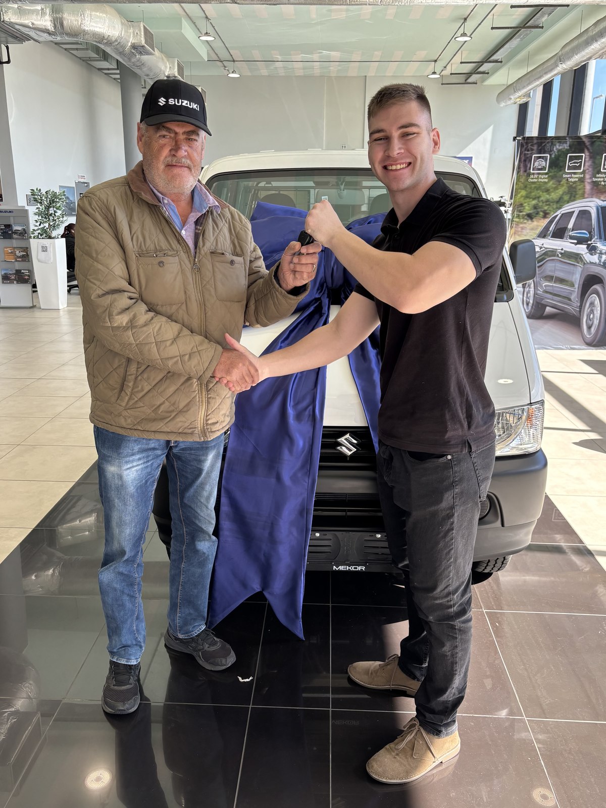 Client receiving keys to a new Suzuki from Jean Joubert