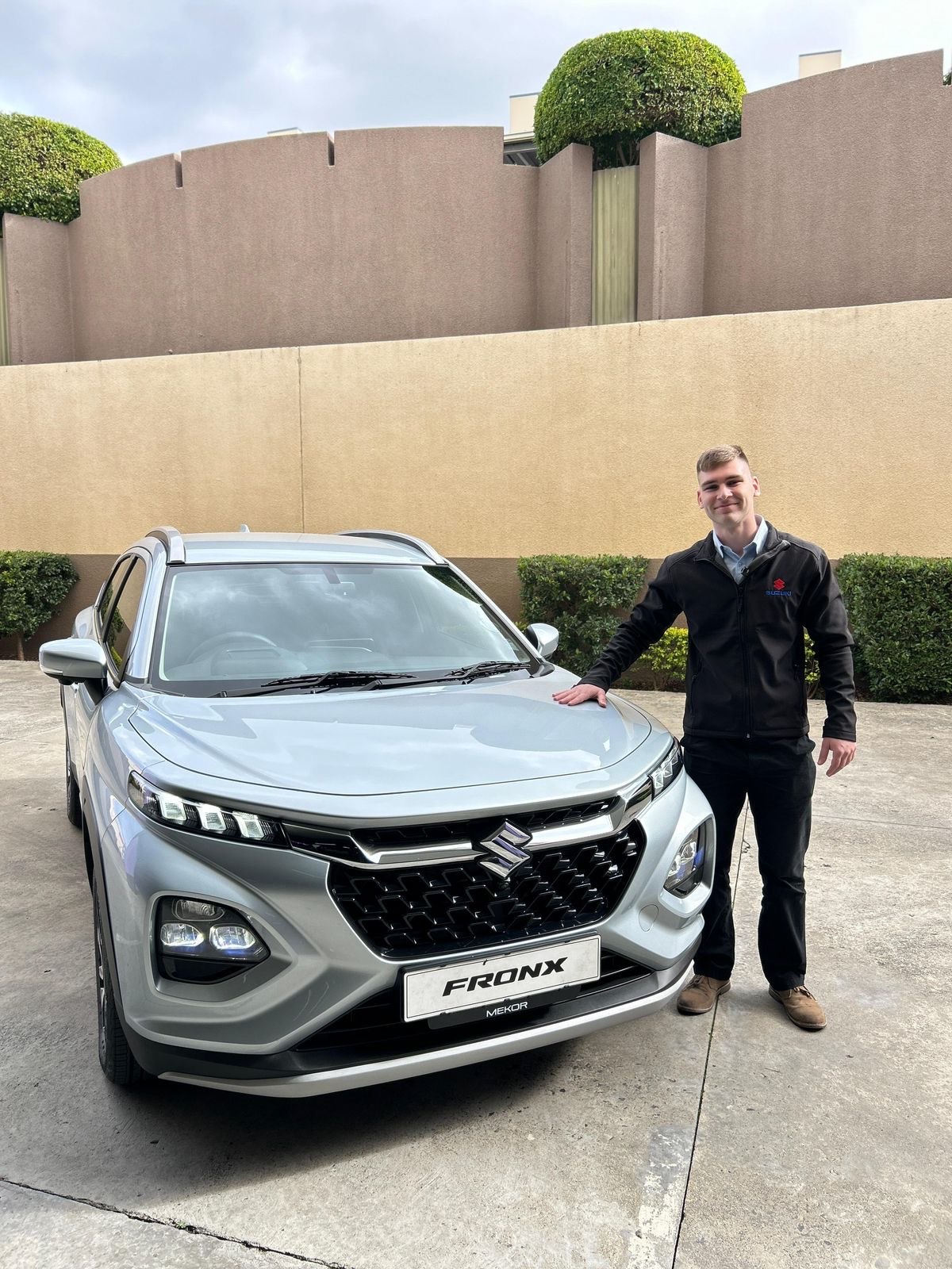 Jean Joubert standing beside a silver Suzuki Fronx